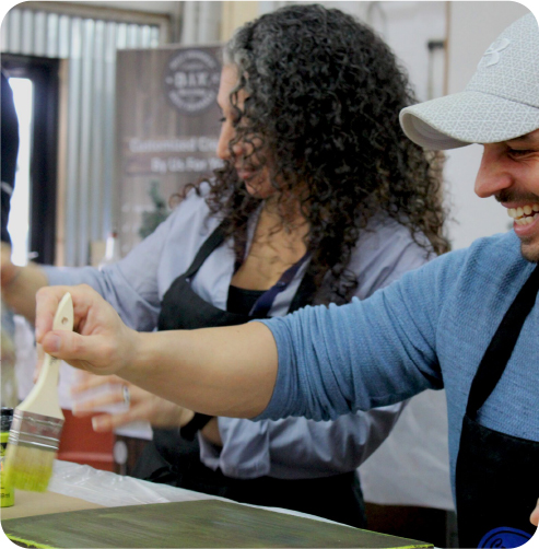 Group of people painting a craft